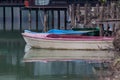 Small boats tied to a wooden dock day shot on lake Royalty Free Stock Photo