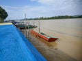 Small boats that are used as a means of transportation for the surrounding community are leaning on the banks of the Kayan River Royalty Free Stock Photo