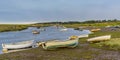 Small boats waiting for the tide to come in on the lower reaches of the River Glaven, Norfolk Royalty Free Stock Photo