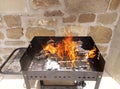 Homemade barbecue with firewood under beautiful orange flames