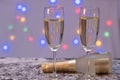 A small bottle of champagne and two full glasses of champagne are on the table Royalty Free Stock Photo