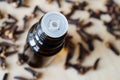 Small bottle with essential clove oil. Aromatherapy, spa and herbal medicine ingredients. Top view Royalty Free Stock Photo