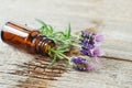 Small bottle with essential oil and lavender flowers. Aromatherapy, homemade spa, beauty treatment concept. Old wooden background Royalty Free Stock Photo