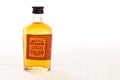 A small bottle of Kentucky Straight `Frontier` Bourbon Whiskey on a white background.