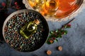 Small bottle of Pistacia terebinthus oil on the bowl of dried seeds on dark wooden background Royalty Free Stock Photo