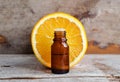 Small bottle with sweet orange essential oil extract, tincture, infusion, perfume. Aromatherapy, spa and herbal medicine Royalty Free Stock Photo