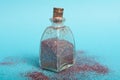 Small bottler with glitter on a green background Royalty Free Stock Photo