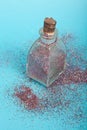 Small bottler with glitter on a green background Royalty Free Stock Photo