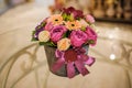 Small bouquet of pink and purple flowers in box