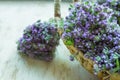 Small Bouquets Bundles of Tied Blooming Fresh Thyme with Blue Flowers in Wicker Basket on Wood Table. Rural Kitchen Garden Royalty Free Stock Photo