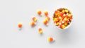 A small bowl of candy corn with some spilled out to the left. Royalty Free Stock Photo