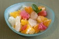 A small bowl of pieces of citrus,