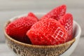 Small bowl of strawberries, leaves removed.