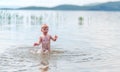 Small boy with blonde hair have fun in sea swimming, summertime, hardening