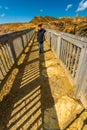 Small boy in bright sunshine on footbridge on stony mountain, Parys Mountain Royalty Free Stock Photo