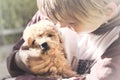 Small boy caresses gently her dog puppy