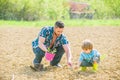 Small boy child help father in farming. new life. soils and fertilizers. rich natural soil. earth day. Eco farm. father