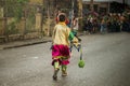 Small boy in colorful carnival costume run away under rain by dominican city street Royalty Free Stock Photo
