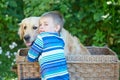 Small boy and cute dog in basket Royalty Free Stock Photo