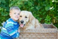 Small boy and cute dog in basket Royalty Free Stock Photo