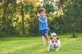 Small boy and dog training to walk on leash without pulling