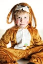 Small boy dressed for bunny sitting on the ground