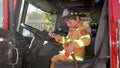 Small boy dressed up as firefighter gets to sit in firetruck