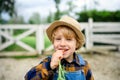Small boy eating carrot on farm, growing organic vegetables concept. Royalty Free Stock Photo