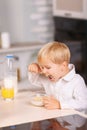 Small boy eats cornflakes with lots of appetite Royalty Free Stock Photo