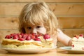 Small boy eats strawberry cake Royalty Free Stock Photo