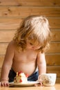 Small boy eats strawberry cake Royalty Free Stock Photo