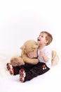 Small boy embraces plush bear