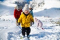 Small boy with family in winter nature, walking in the snow. Royalty Free Stock Photo