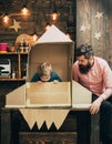 Small boy and father in paper rocket small boy and father play with rocket and dreaming about future career Royalty Free Stock Photo