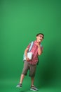 Small boy with glasses, a book and a backpack is tired of studying Royalty Free Stock Photo