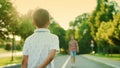 Small boy going on street. Handsome man and boy walking towards each other