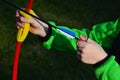 Small boy hands loading arrow to kids 15 lbs tension laminate bow