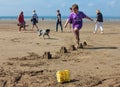 Small boy jumping sandcastles on the beach August 2018