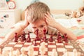 Small boy is hardly concentrated on playing chess game Royalty Free Stock Photo