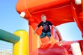 Small boy having fun on a jumping castle