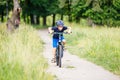 Small boy in helmet riding bicycle in park Royalty Free Stock Photo