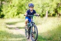 Small boy in helmet riding bicycle in park Royalty Free Stock Photo
