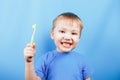 Smile boy cleans a teeth with toothbrush