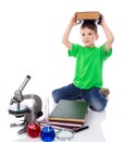 Small boy holds a big book on his head