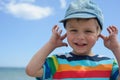 Small boy holds his hands over ears not to hear Royalty Free Stock Photo