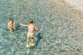 Small boy jumps from stone pier to sea touching water Royalty Free Stock Photo