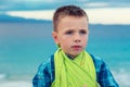 Small boy, kid at the beach looking at you camera pensive Royalty Free Stock Photo