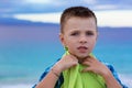 Small boy, kid at the beach looking at you camera pensive Royalty Free Stock Photo