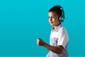 Small boy listening to music on bluetooth headphones smiling and dancing Royalty Free Stock Photo