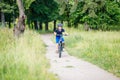 Small boy in helmet riding bicycle in park Royalty Free Stock Photo